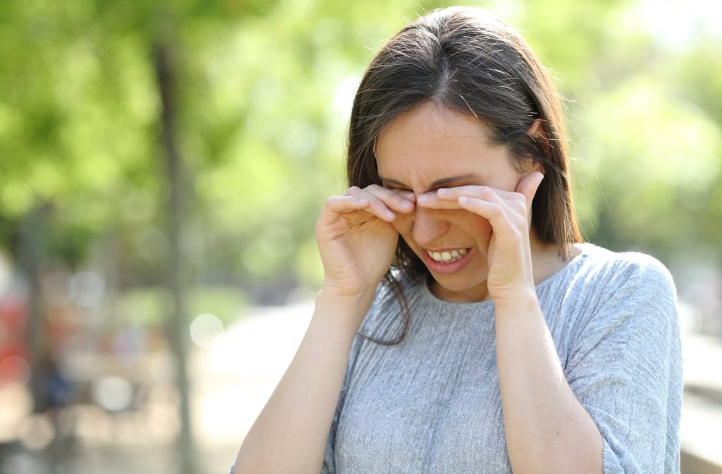 Woman rubbing her eyes because of dry eye or allergies