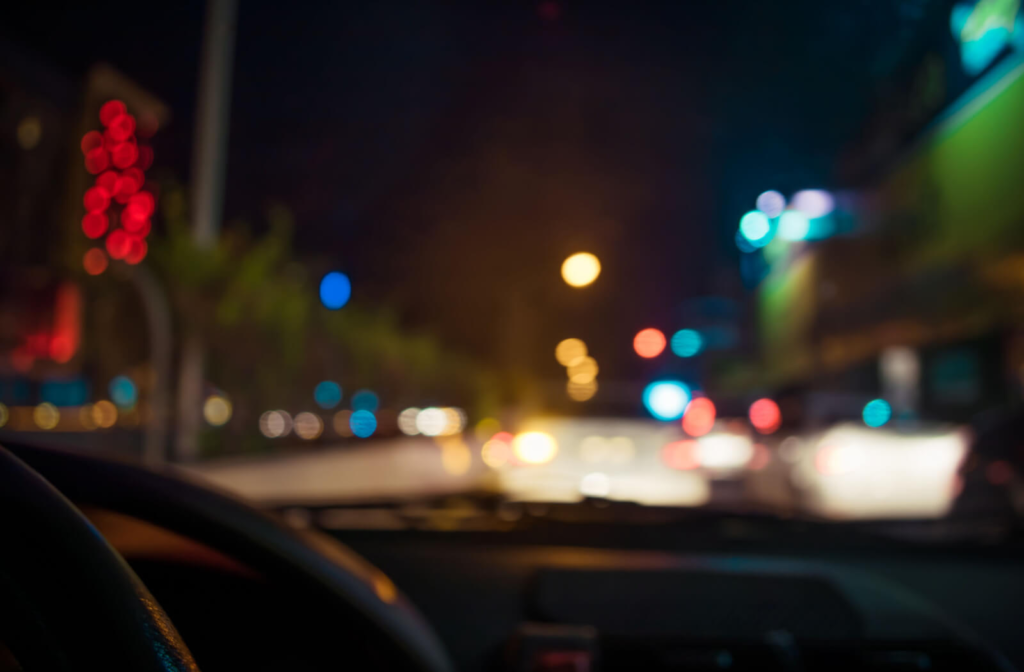 Blurry view of a busy street through the car windshield.